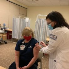 Nursing student administers vaccine to patient